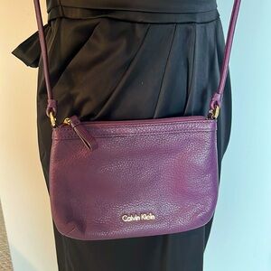 Calvin Klein purple leather crossbody bag. Zipper top and inner zipper pocket